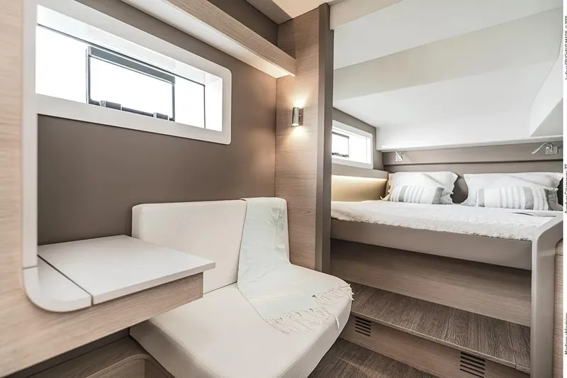 Slide: The Image of Interior of 2025 Aventura 37 Trawler, featuring modern seating and cozy sleeping area. - 12