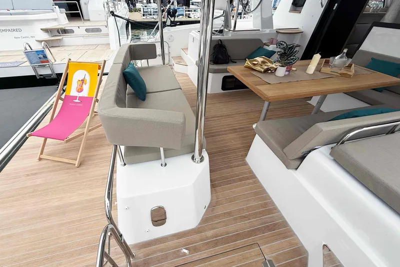 Slide: The Image of 2026 Aventura 37 Explorer Trawler deck with seating, table, and colorful deck chair. - 3