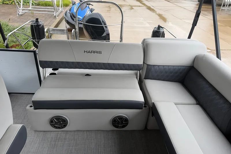 Slide: The Image of 2023 Harris Sunliner 230 boat interior with gray seating and speaker system. - 14