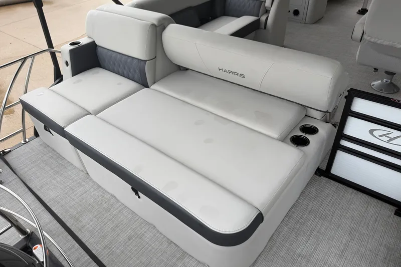 Slide: The Image of 2023 Harris Sunliner 230 boat interior with gray cushioned seating and cup holders. - 16