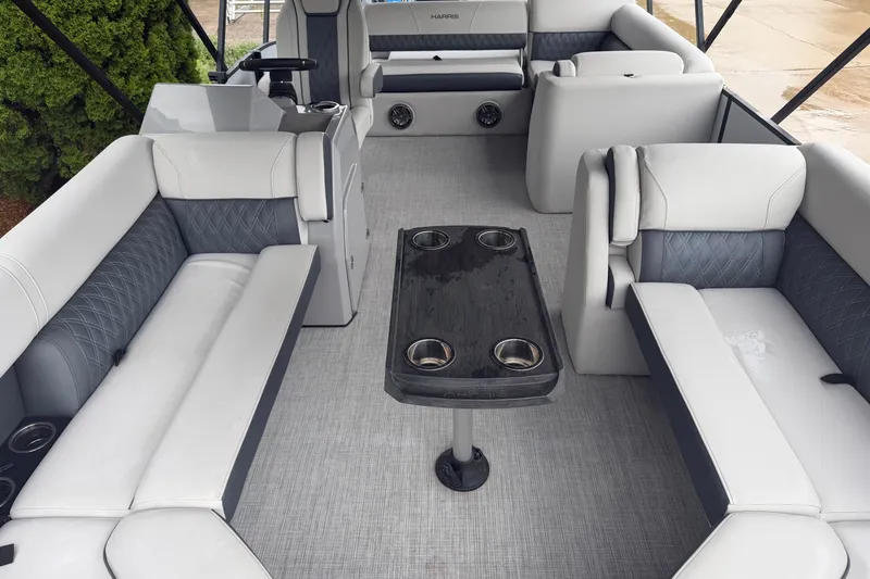 Slide: The Image of Luxurious interior of 2023 Harris Sunliner 230 pontoon boat with plush seating and table. - 2
