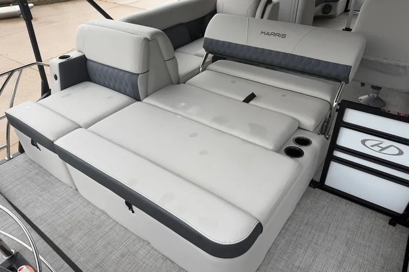 Slide: The Image of 2023 Harris Sunliner 230 boat interior with luxurious gray seating and cup holders. - 17