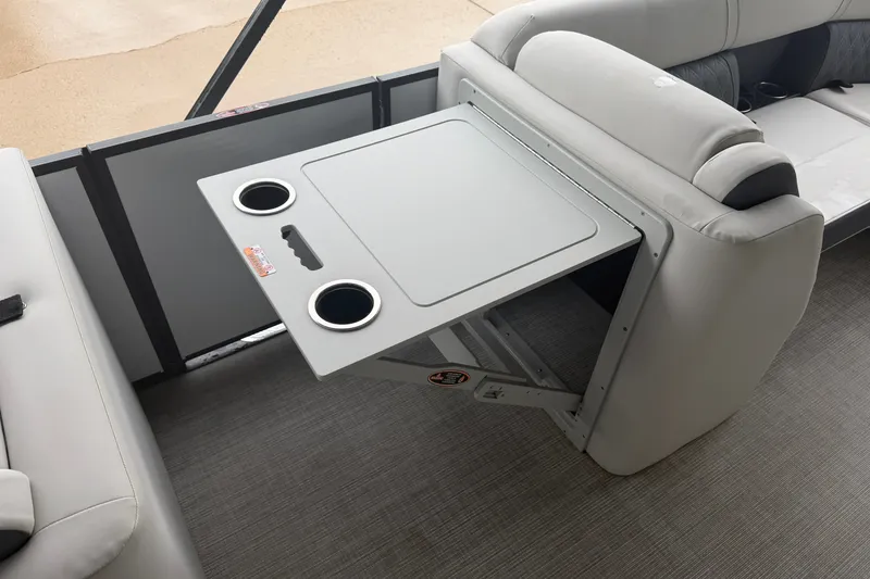 Slide: The Image of 2023 Harris Sunliner 230 boat interior with foldable table and cup holders. - 7