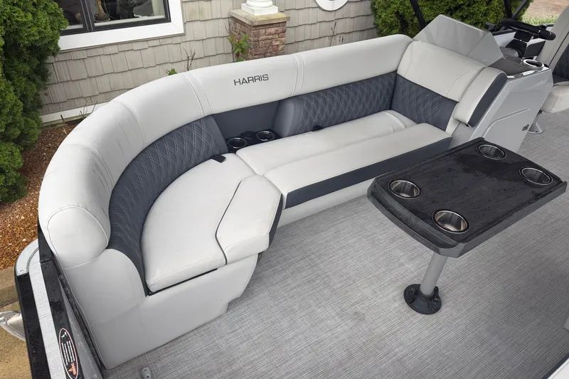 Slide: The Image of Luxurious seating area on 2023 Harris Sunliner 230 pontoon boat with cup holders and table. - 4