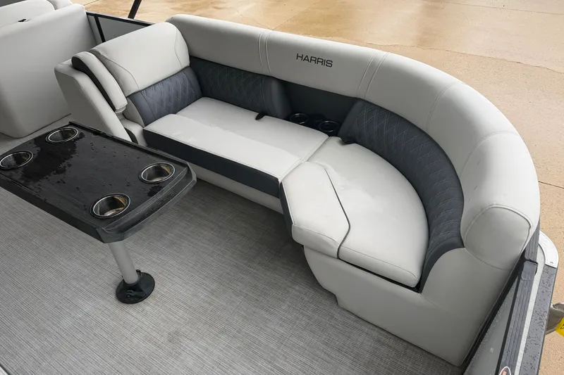 Slide: The Image of 2023 Harris Sunliner 230 boat interior with plush seating and cup holders. - 3