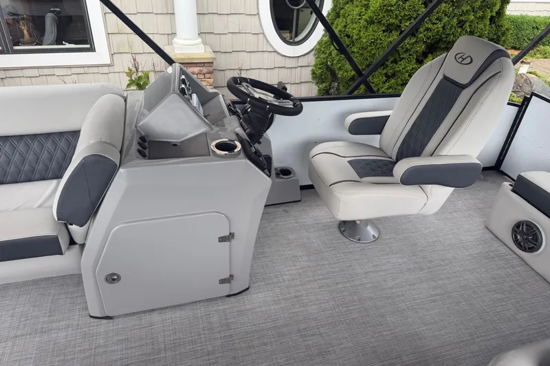 Slide: The Image of 2023 Harris Sunliner 230 boat interior with modern helm and comfortable seating. - 8