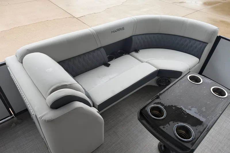 Slide: The Image of 2023 Harris Sunliner 230 boat interior with gray seating and cup holders. - 5