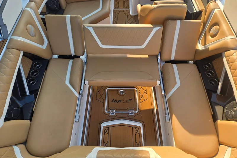 Slide: The Image of Luxurious interior of 2020 Tigé 23ZX boat with tan leather seating and wood flooring. - 18