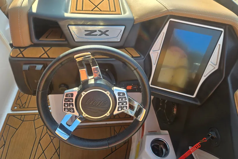 Slide: The Image of Steering wheel and dashboard of 2020 Tigé 23ZX boat with touchscreen display. - 12