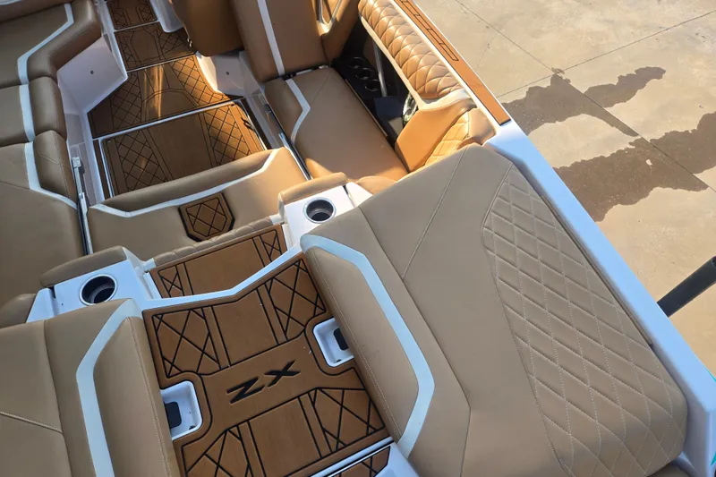 Slide: The Image of 2020 Tigé 23ZX boat interior with tan upholstery and custom flooring design. - 5