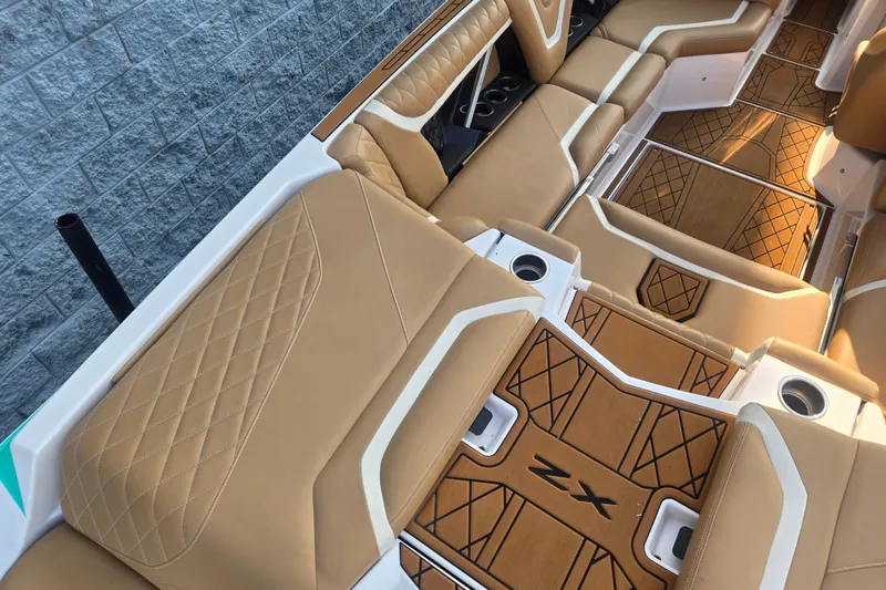 Slide: The Image of Luxurious interior of 2020 Tigé 23ZX boat with tan leather seating and stylish flooring. - 6