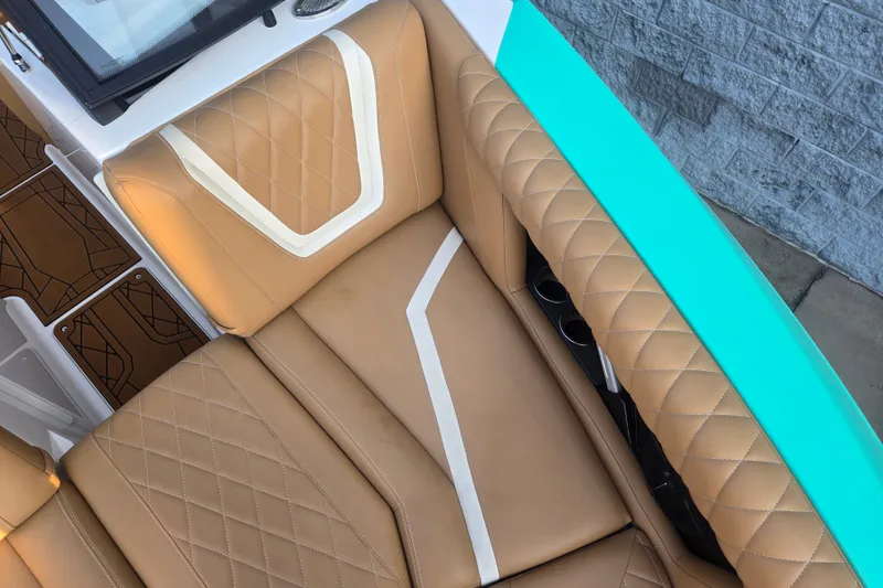 Slide: The Image of 2020 Tigé 23ZX boat interior with tan quilted seats and turquoise accents. - 15
