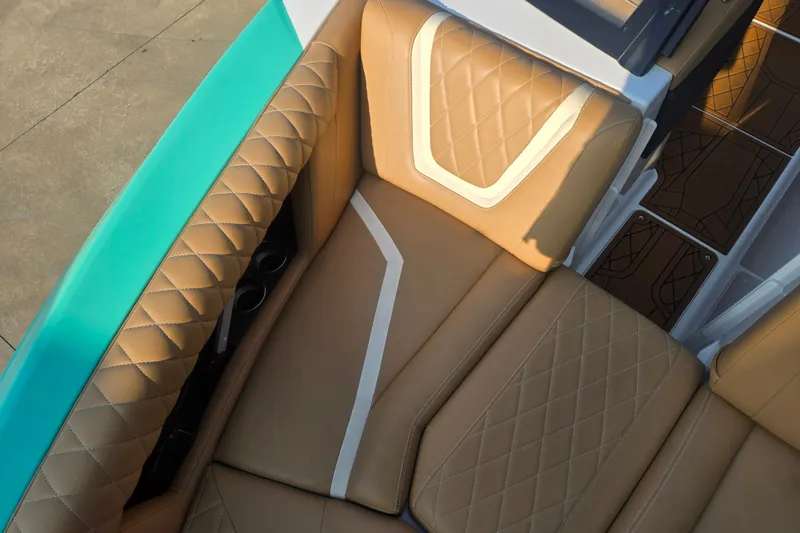 Slide: The Image of 2020 Tigé 23ZX boat interior with tan quilted seats and teal accents. - 14