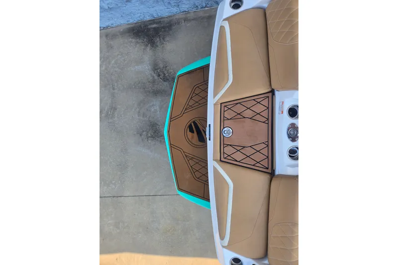 Slide: The Image of 2020 Tigé 23ZX boat interior with tan seating and teal accents. - 19