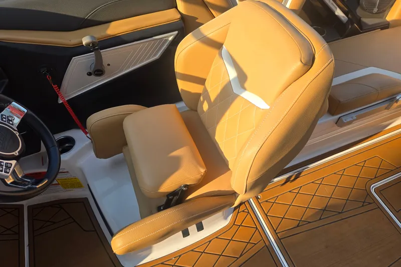 Slide: The Image of 2020 Tigé 23ZX boat interior with tan leather seating and modern steering wheel. - 11
