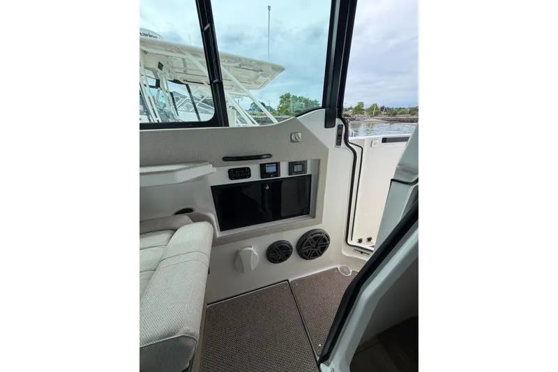 Slide: The Image of Interior view of 2025 Saxdor 320 GTC boat, featuring seating and control panel. - 22