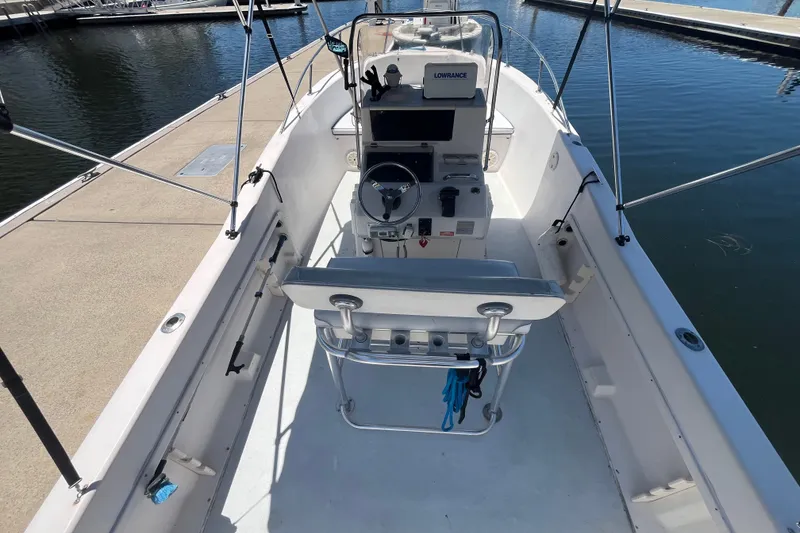 Slide: The Image of 1994 Grady-White Escape 209 boat interior with steering console and seating at dock. - 8