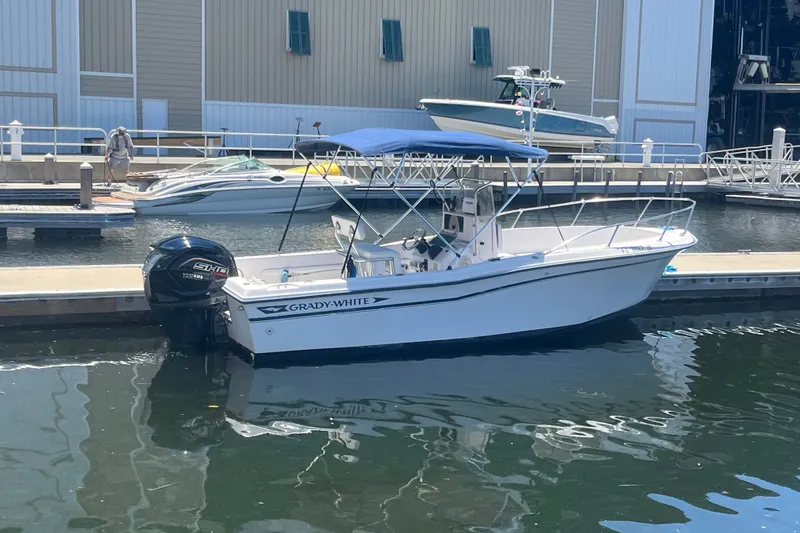Slide: The Image of 1994 Grady-White Escape 209 boat docked with Yamaha outboard motor. - 5