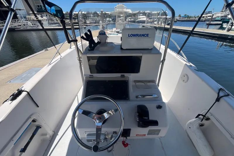 Slide: The Image of 1994 Grady-White Escape 209 boat cockpit with steering wheel and Lowrance equipment at marina. - 16