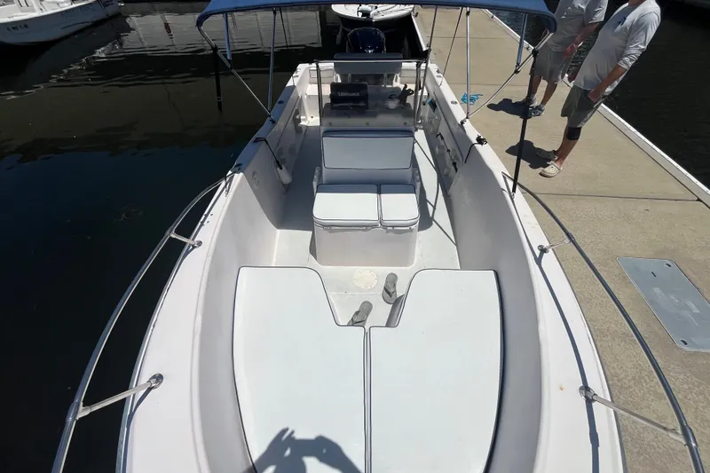 Slide: The Image of 1994 Grady-White Escape 209 boat docked, featuring spacious seating and canopy. - 11