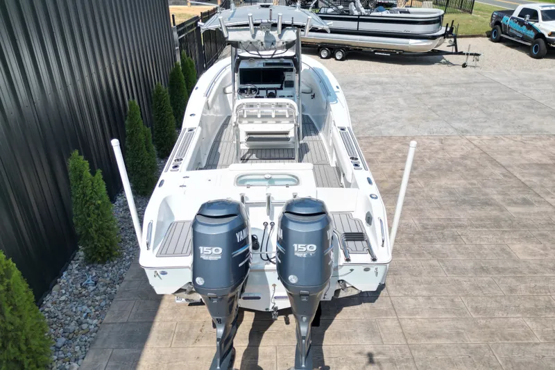 Slide: The Image of 2008 Sea Hunt Triton 260 boat with dual Yamaha 150 engines, docked outdoors. - 18