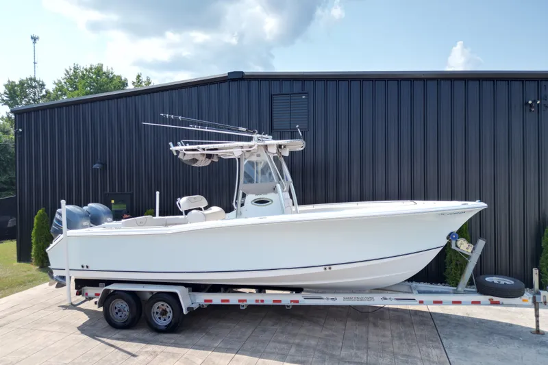Slide: The Image of 2008 Sea Hunt Triton 260 boat on trailer, parked outside a black building. - 26