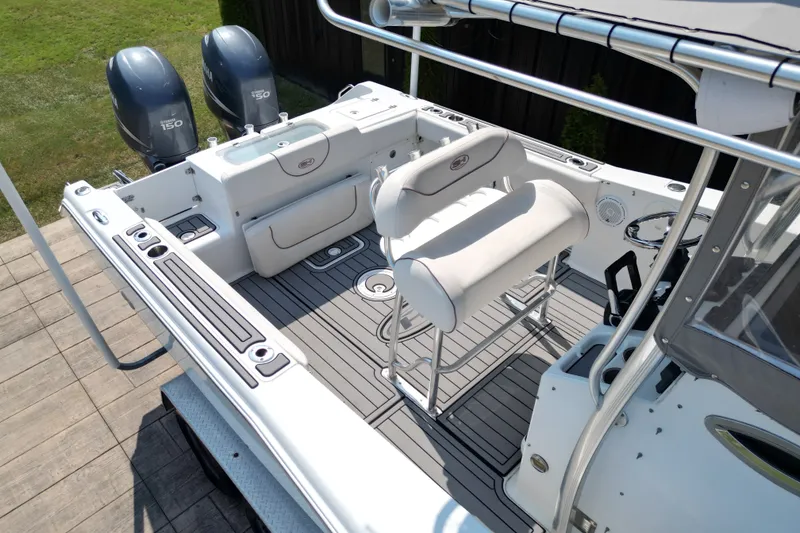 Slide: The Image of 2008 Sea Hunt Triton 260 boat interior with dual engines and seating area. - 11