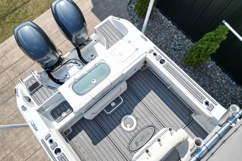 Slide: The Image of 2008 Sea Hunt Triton 260 boat deck with dual engines and fishing rod holders. - 4