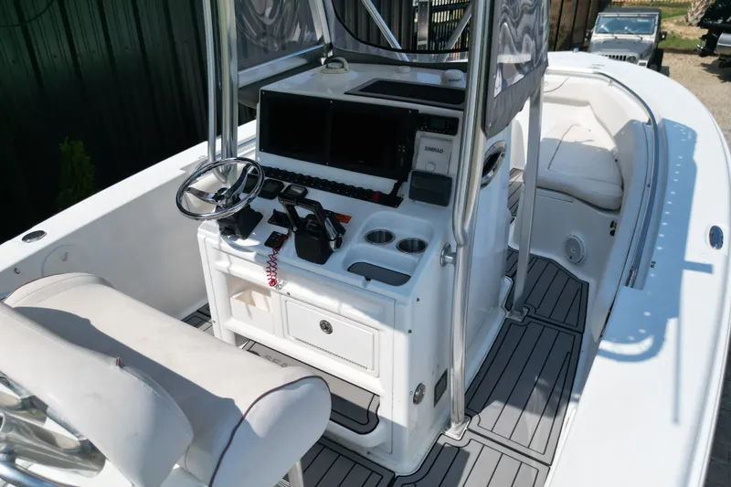 Slide: The Image of 2008 Sea Hunt Triton 260 boat cockpit with steering wheel and navigation equipment. - 16