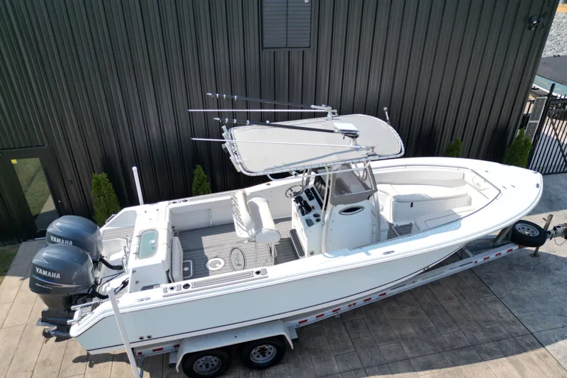 Slide: The Image of 2008 Sea Hunt Triton 260 boat on trailer, featuring dual Yamaha engines. - 3