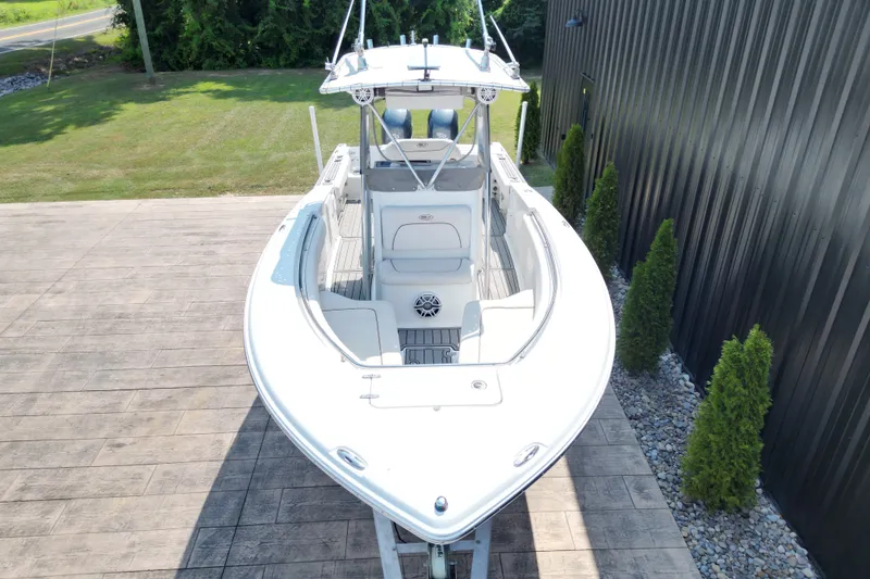 Slide: The Image of 2008 Sea Hunt Triton 260 boat on display, viewed from above, near a black building. - 13