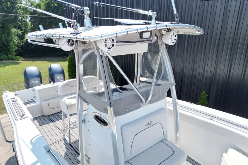 Slide: The Image of 2008 Sea Hunt Triton 260 boat with dual engines and T-top, docked outdoors. - 6