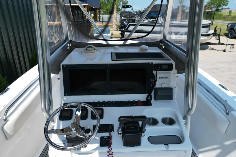 Slide: The Image of 2008 Sea Hunt Triton 260 boat dashboard with steering wheel and navigation equipment. - 10