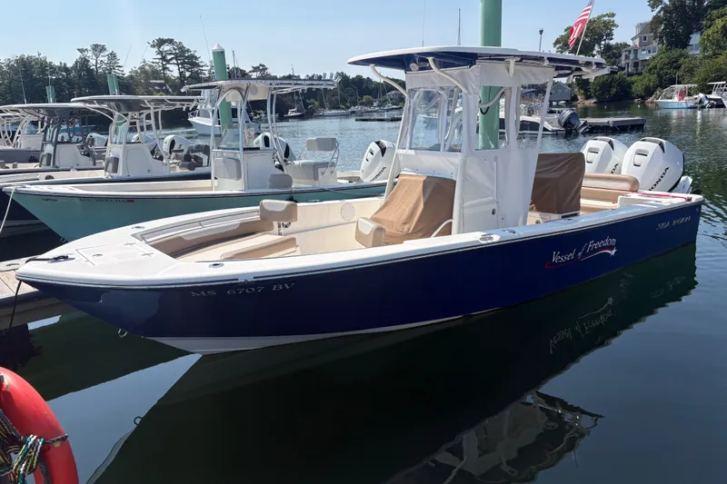 Slide: The Image of 2024 Sea Born LX24 Center Console boat docked in a marina. - 17