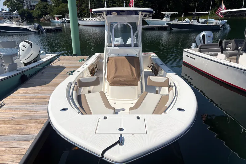 Slide: The Image of 2024 Sea Born LX24 Center Console boat docked at marina, featuring spacious seating. - 16