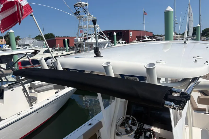 Slide: The Image of 2024 Sea Born LX24 Center Console boat docked at marina with American flag. - 10