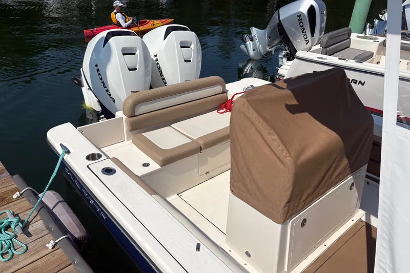 Slide: The Image of 2024 Sea Born LX24 Center Console boat with Honda engines docked by the water. - 14