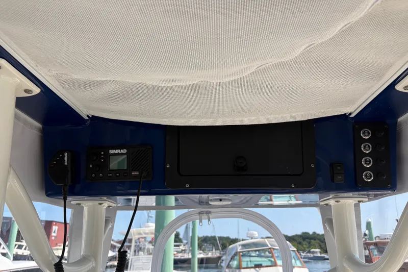 Slide: The Image of 2024 Sea Born LX24 Center Console boat dashboard with Simrad electronics and control panel. - 12