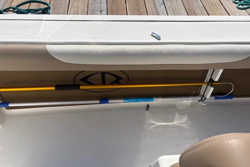 Slide: The Image of 2024 Sea Born LX24 Center Console boat interior with storage compartment and fishing rod holder. - 8