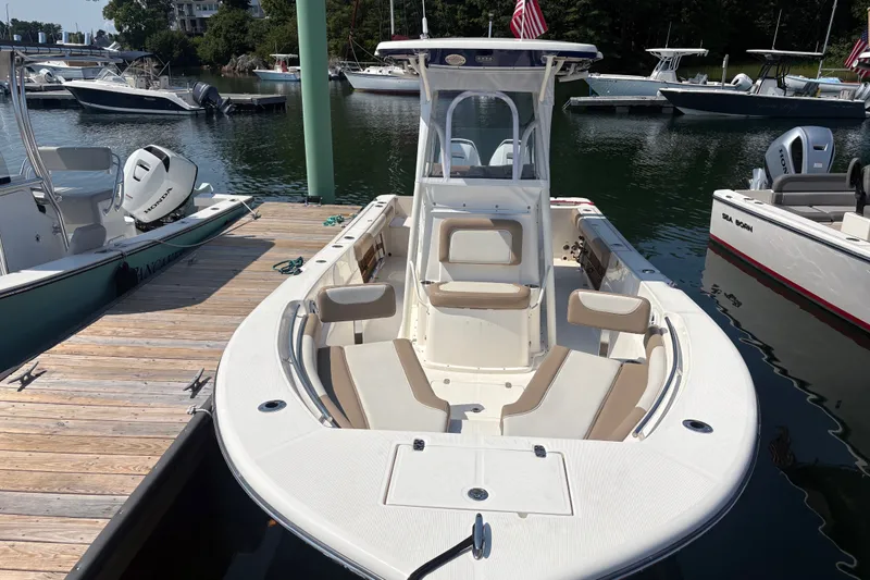 Slide: The Image of 2024 Sea Born LX24 Center Console boat docked in a marina. - 15