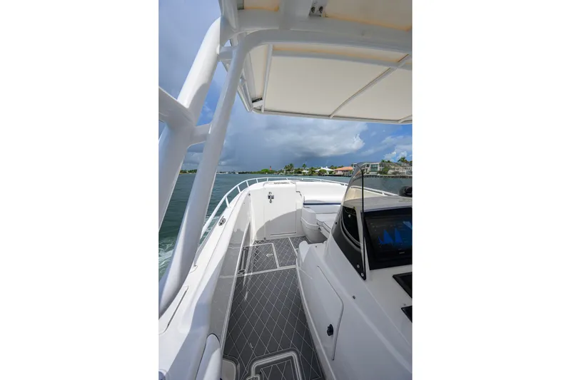 Slide: The Image of 2009 Intrepid 370 boat cruising on open water under cloudy skies. - 8