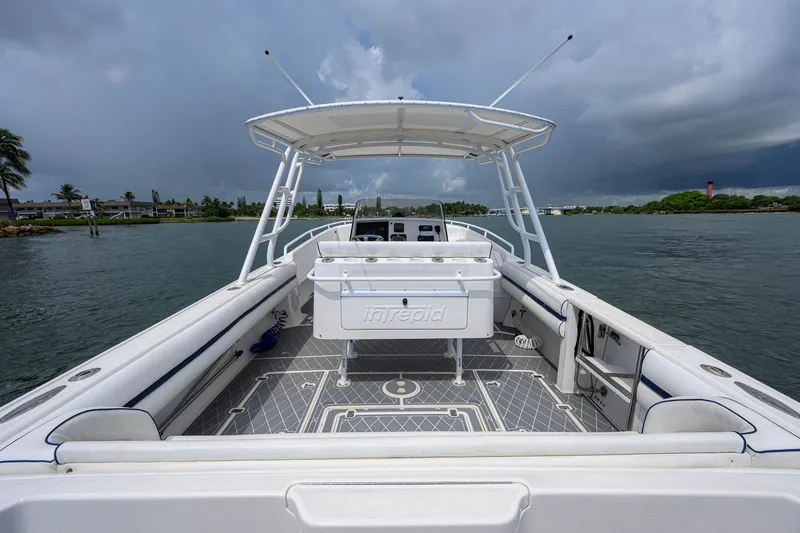 Slide: The Image of 2009 Intrepid 370 boat on water, featuring spacious deck and overcast sky. - 16