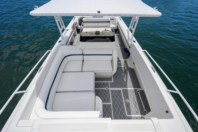 Slide: The Image of 2009 Intrepid 370 boat with spacious seating and canopy on calm water. - 14