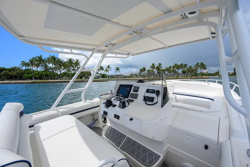 Slide: The Image of 2009 Intrepid 370 boat interior with navigation equipment, cruising near tropical shoreline. - 12