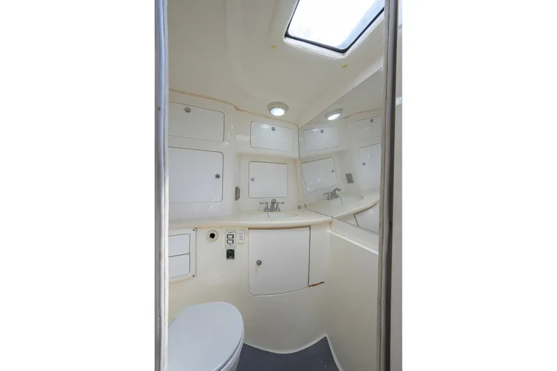 Slide: The Image of Compact bathroom interior of 2009 Intrepid 370 boat with sink, toilet, and storage cabinets. - 22