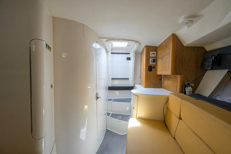 Slide: The Image of Interior of a 2009 Intrepid 370 boat with beige seating and wooden cabinetry. - 19