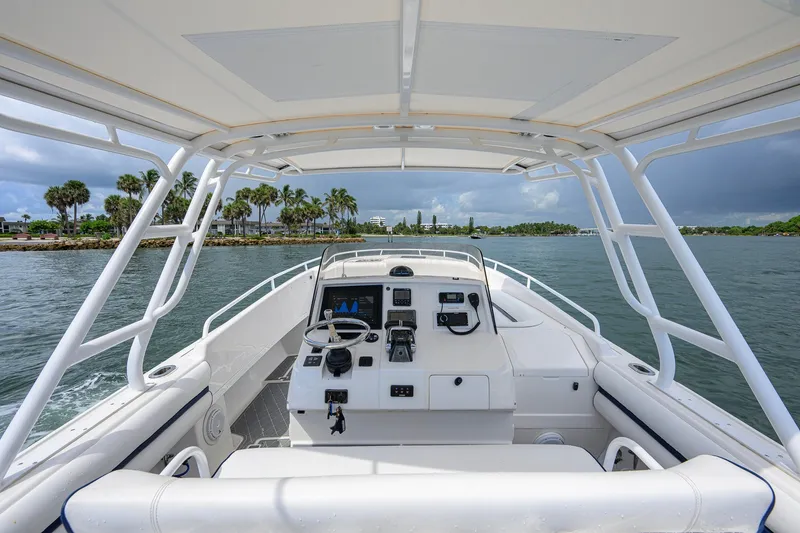 Slide: The Image of Cockpit view of 2009 Intrepid 370 boat navigating through scenic waters. - 9