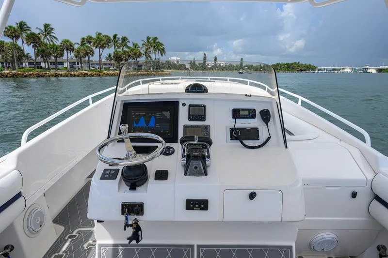 Slide: The Image of Helm of 2009 Intrepid 370 boat with navigation equipment, steering wheel, and ocean view. - 10