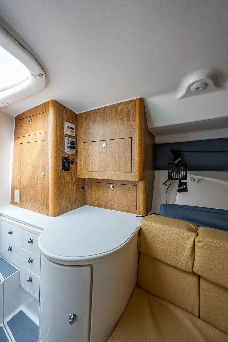 Slide: The Image of Interior of a 2009 Intrepid 370 with wood cabinetry and beige upholstery. - 6