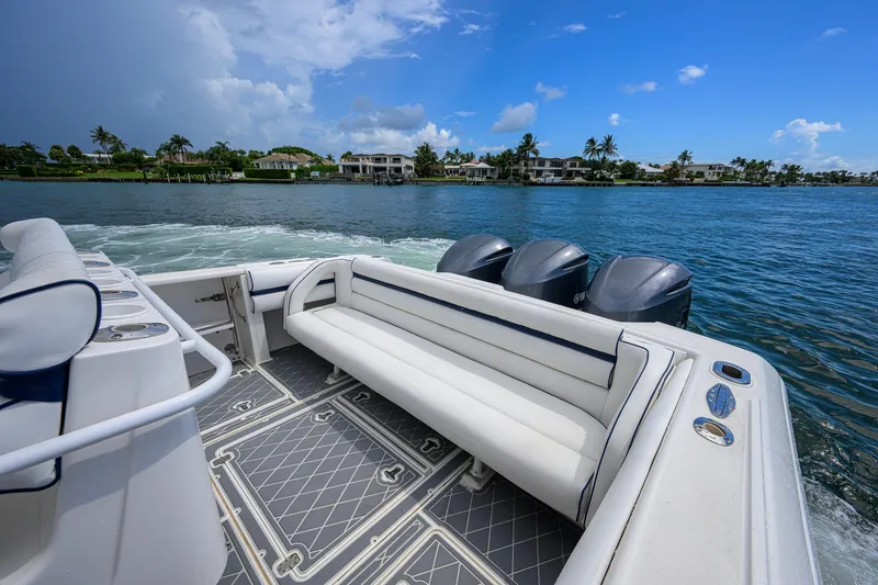 Slide: The Image of 2009 Intrepid 370 boat with triple engines cruising on a scenic waterway. - 18